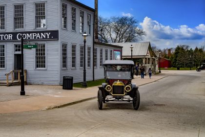 Vintage automobile driving through historic Greenfield Village in Dearborn Michigan