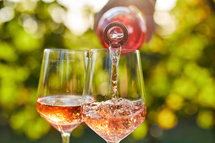 Wine being poured into glasses at a winery along the Lenawee County wine trail in Michigan